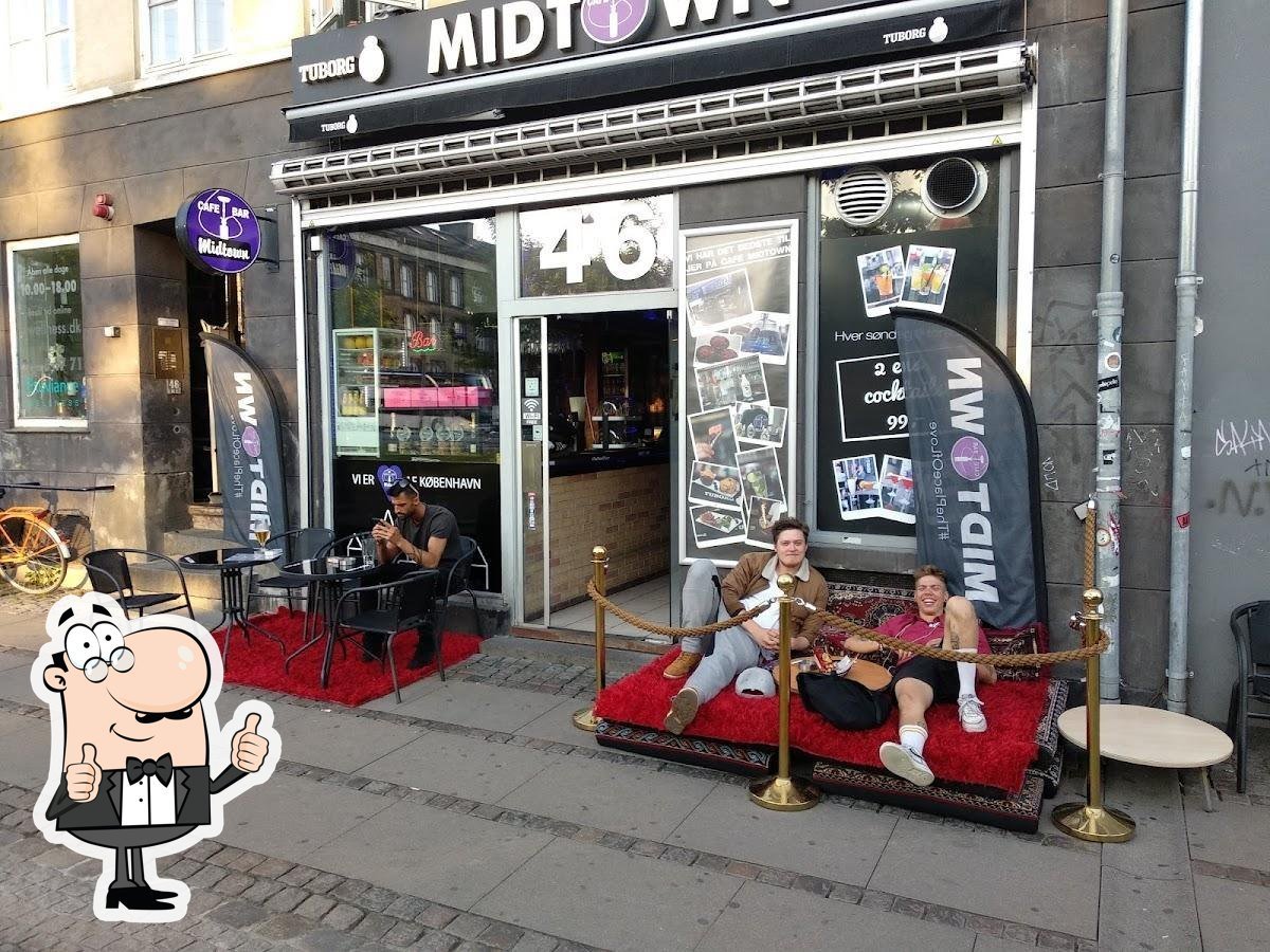 Storefront of Midtown with red velvet seating outside