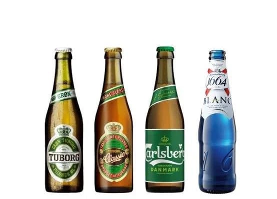 Four beer bottles lined up: Tuborg, Carlsberg, Carlsberg Danmark, and Kronenbourg 1664 Blanc